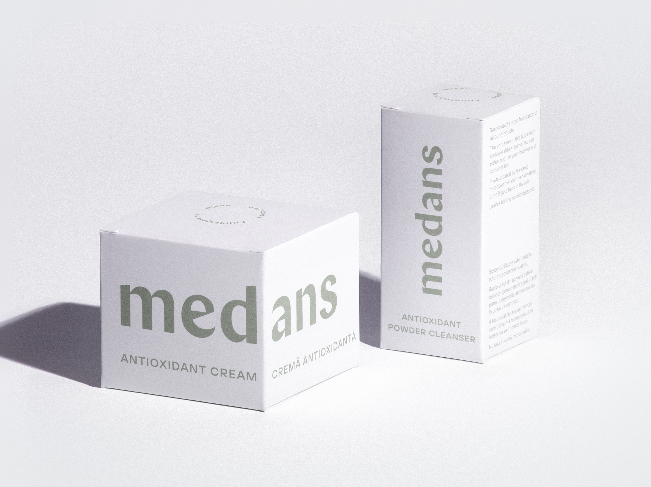Two boxes of medans skincare products on a light gray background