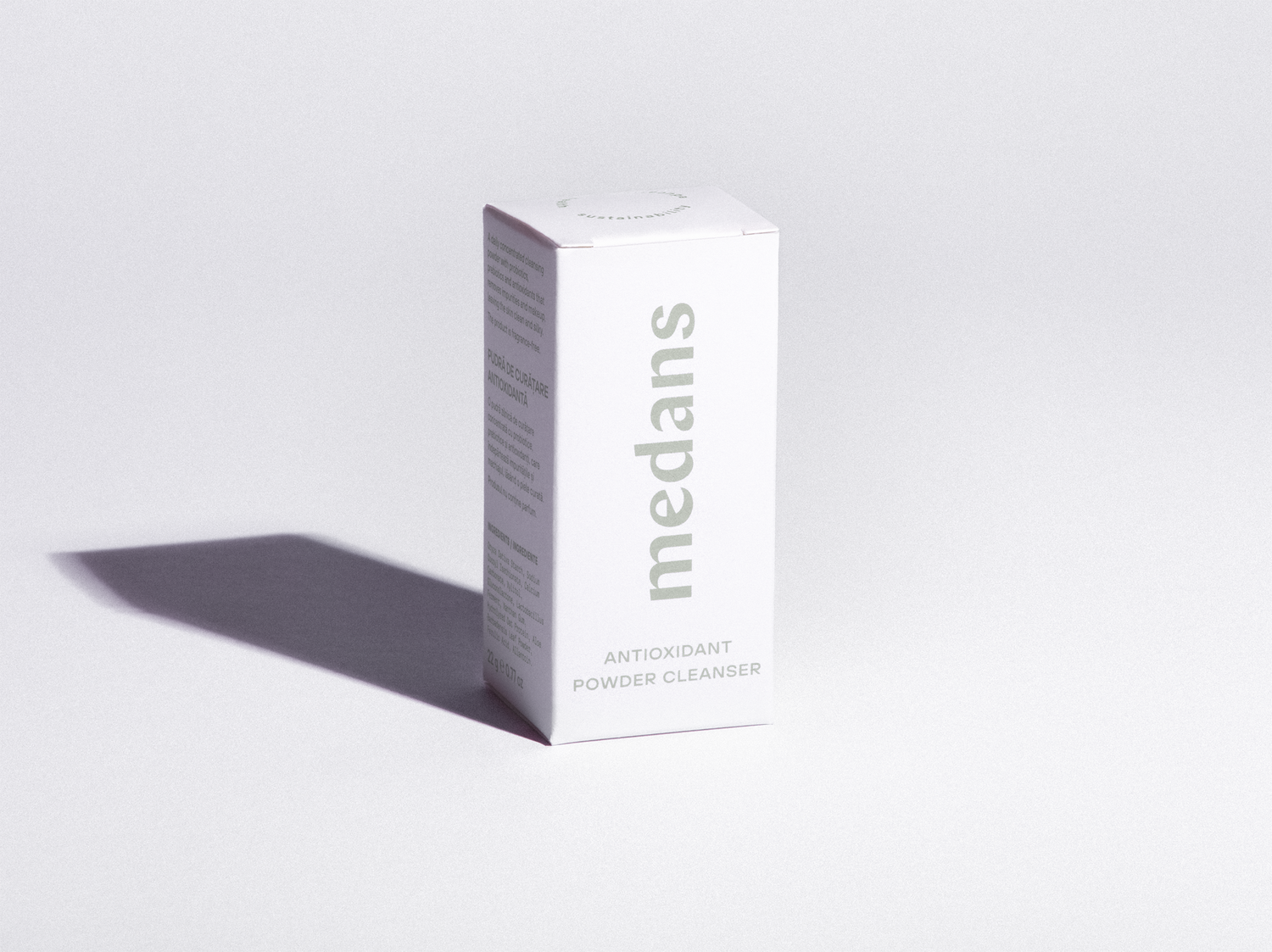Box of medans antioxidant powder cleanser on a light gray background