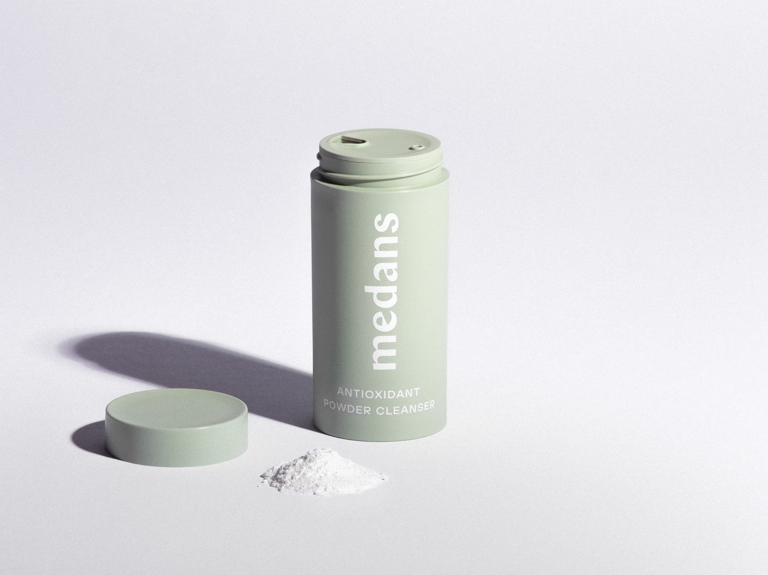 Green cylindrical medans container branding on a light gray background