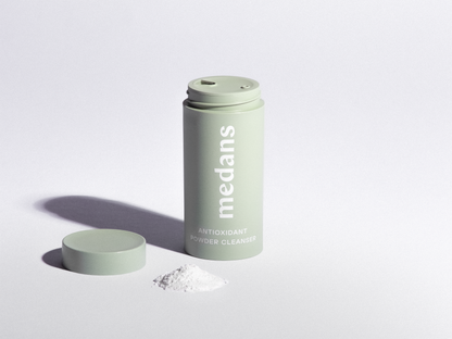 Green cylindrical medans container branding on a light gray background